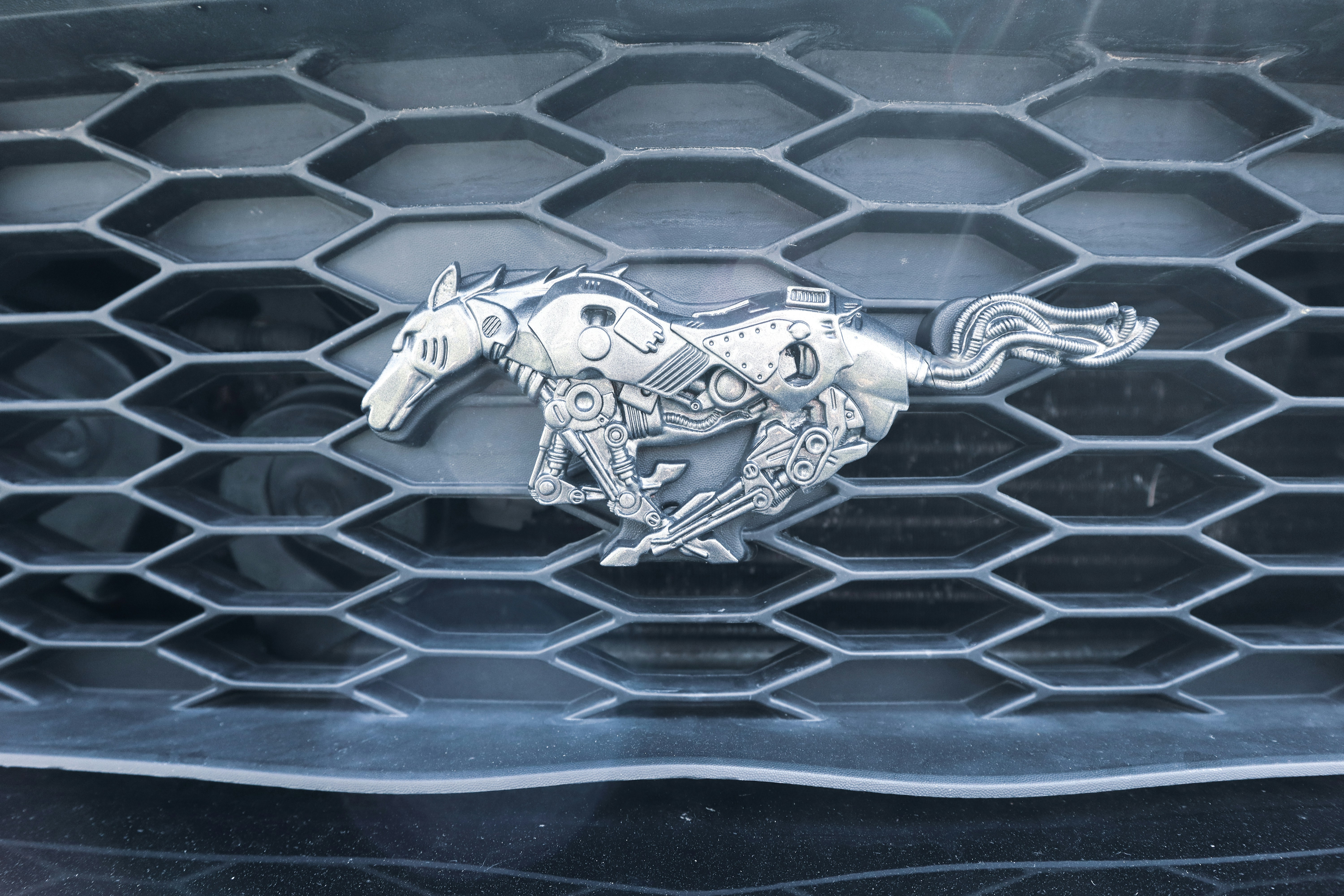 A horse logo in front of a car